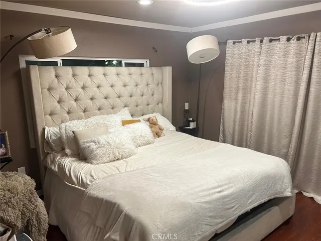 a bedroom with a bed and curtain