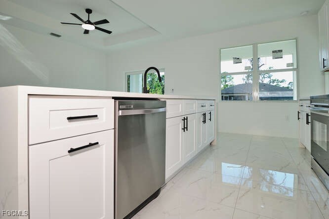 3421 55th Street West Lehigh Acres, FL 33971 - Photo 14 of 38 a kitchen with stainless steel appliances a refrigerator and a stove