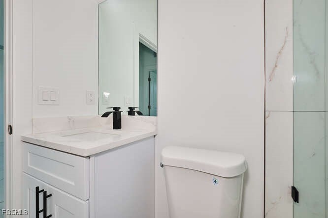 3421 55th Street West Lehigh Acres, FL 33971 - Photo 26 of 38 a bathroom with a sink toilet and mirror