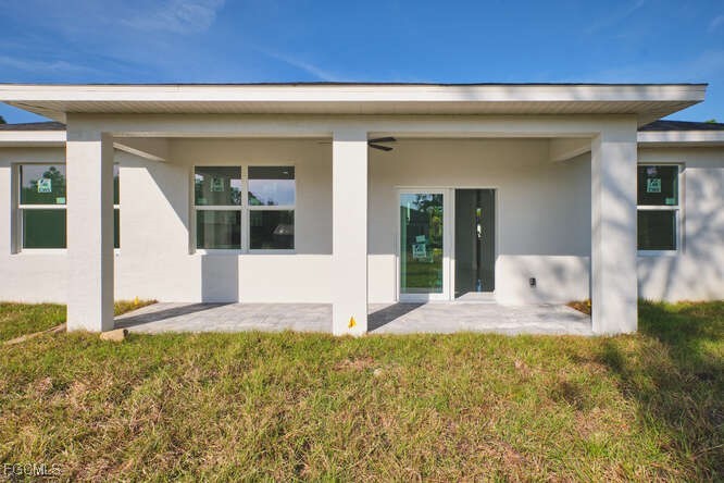 3421 55th Street West Lehigh Acres, FL 33971 - Photo 31 of 38 a front view of a house with a yard