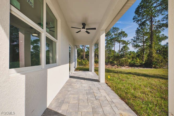 3421 55th Street West Lehigh Acres, FL 33971 - Photo 33 of 38 a view of a large room with floor to ceiling windows and yard