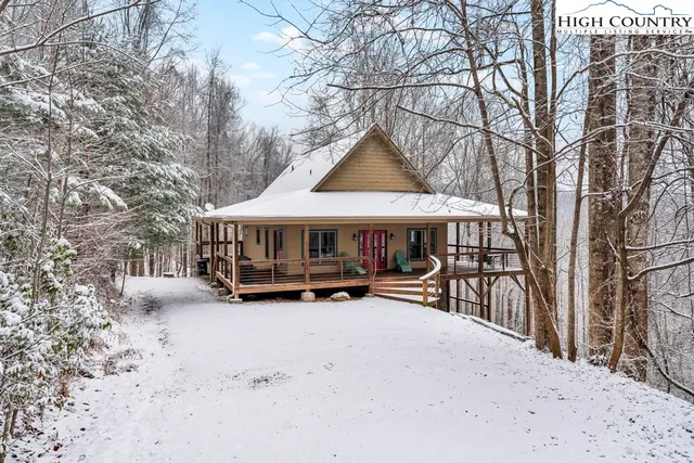 a view of a house with yard and sitting area