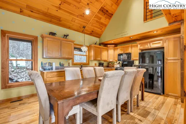 a dining room with furniture and a kitchen view