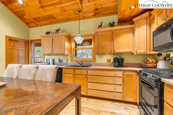 a kitchen with stainless steel appliances granite countertop a sink and cabinets