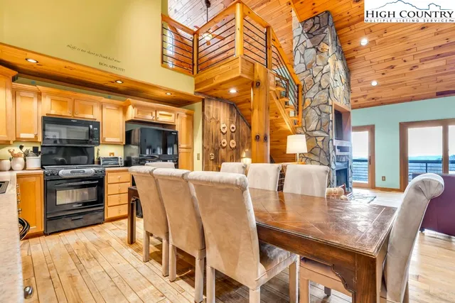 a dining table with chairs and kitchen view