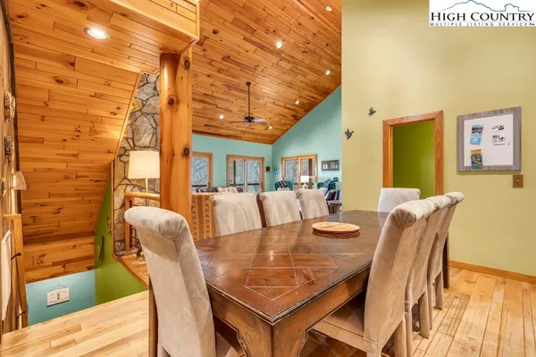 a dining room with furniture and wooden floor