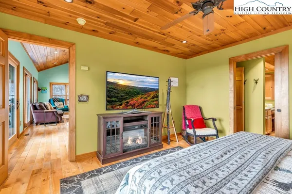 a bed room with a bed and a flat screen tv