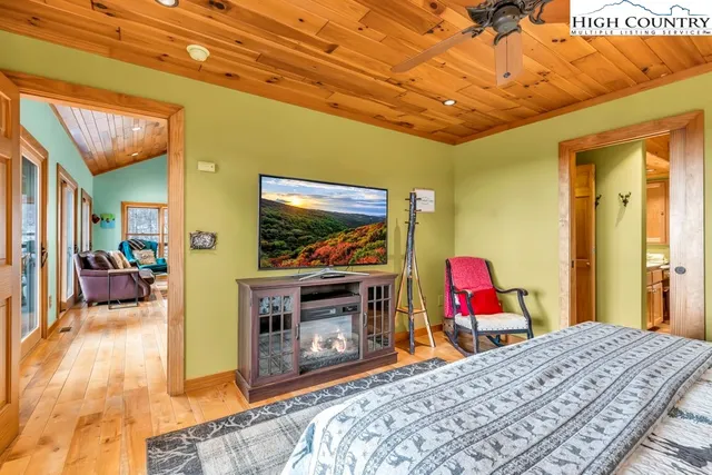 a bed room with a bed and a flat screen tv
