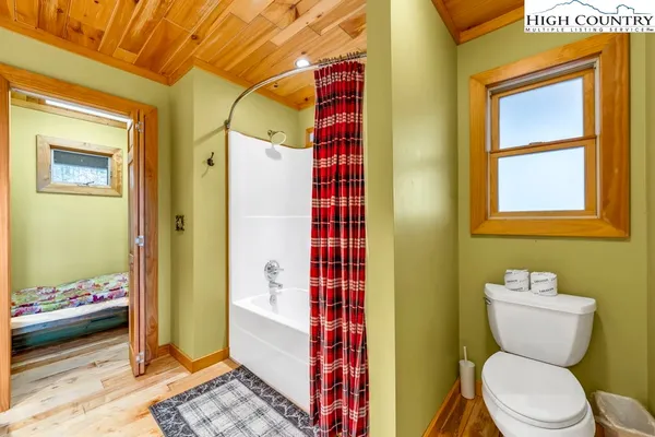 a bathroom with a toilet and a shower