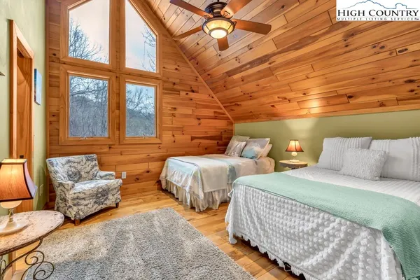 a bedroom with double bed and a couch