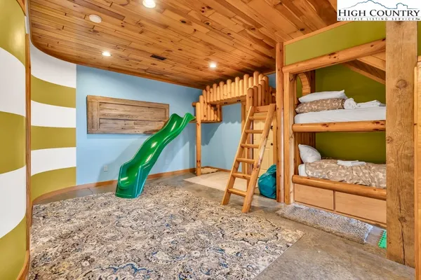 a living room with a pool table and large windows