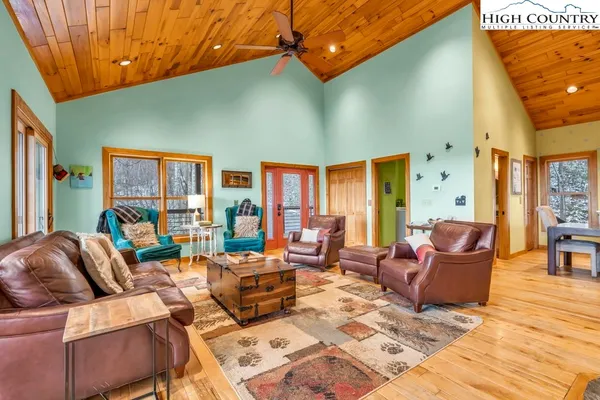a living room with furniture a rug and a window