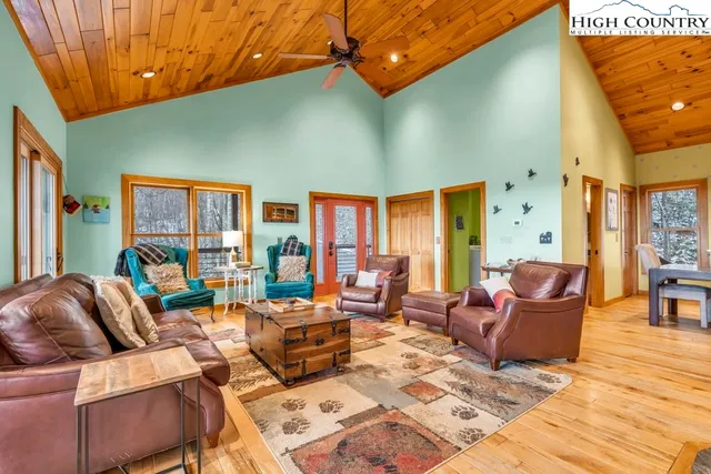 a living room with furniture a rug and a window