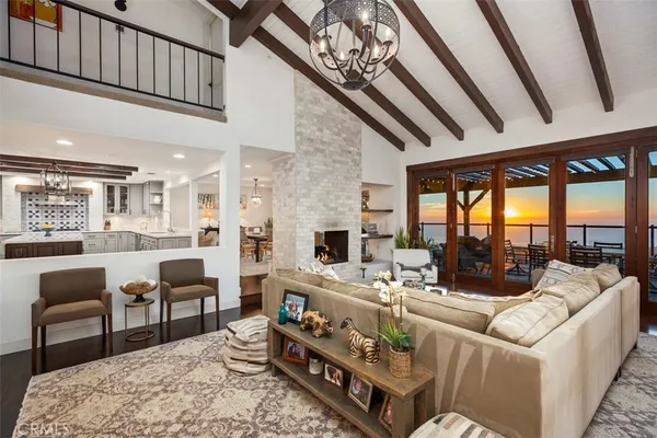 a living room with furniture a fireplace and a table