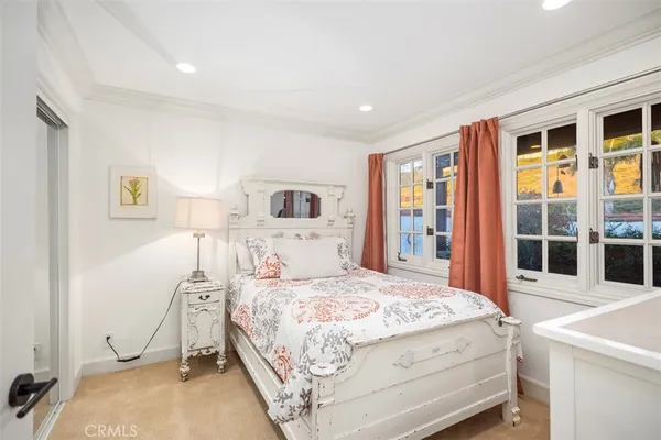 a bedroom with a bed and a large window