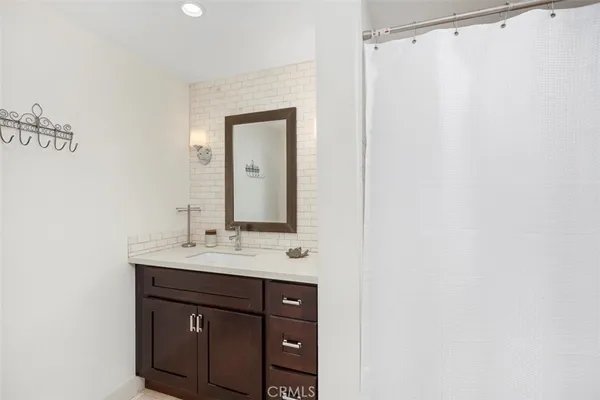 a bathroom with a sink vanity and a mirror