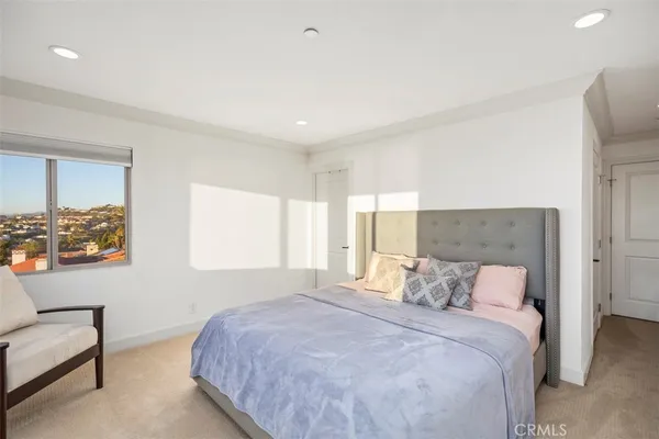 a bedroom with a bed and a painting on the wall