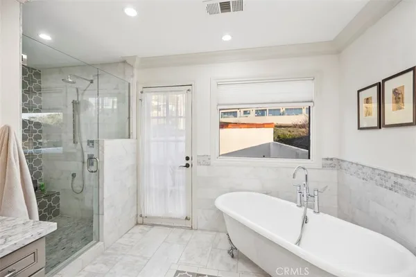 a bathroom with a tub shower and sink