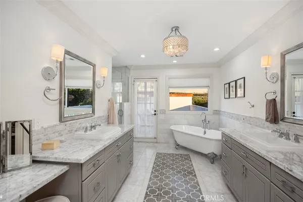 a spacious bathroom with a granite countertop tub sink and mirror