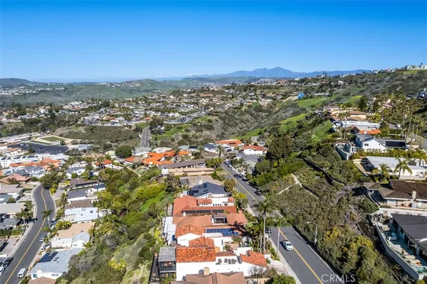 an aerial view of residential building and ocean