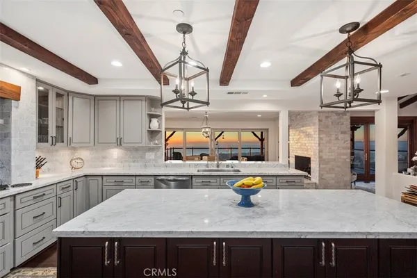 a kitchen with stainless steel appliances granite countertop a sink a stove counter space and appliances