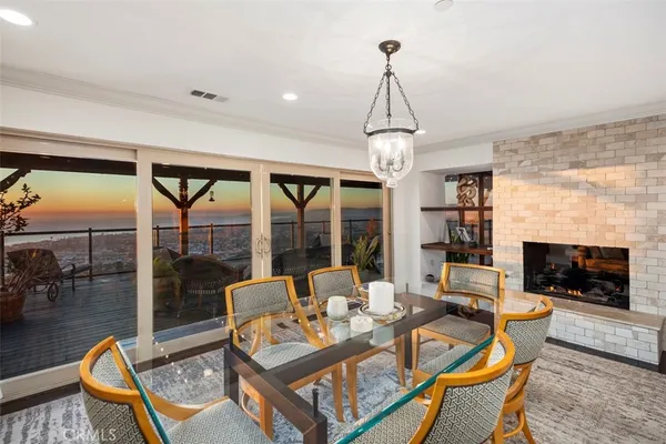a living room with furniture a flat screen tv and a floor to ceiling window