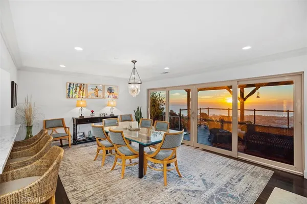 a view of a dining room with furniture wooden floor and a rug