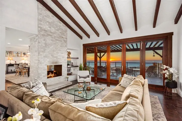 a living room with furniture large window and a fireplace