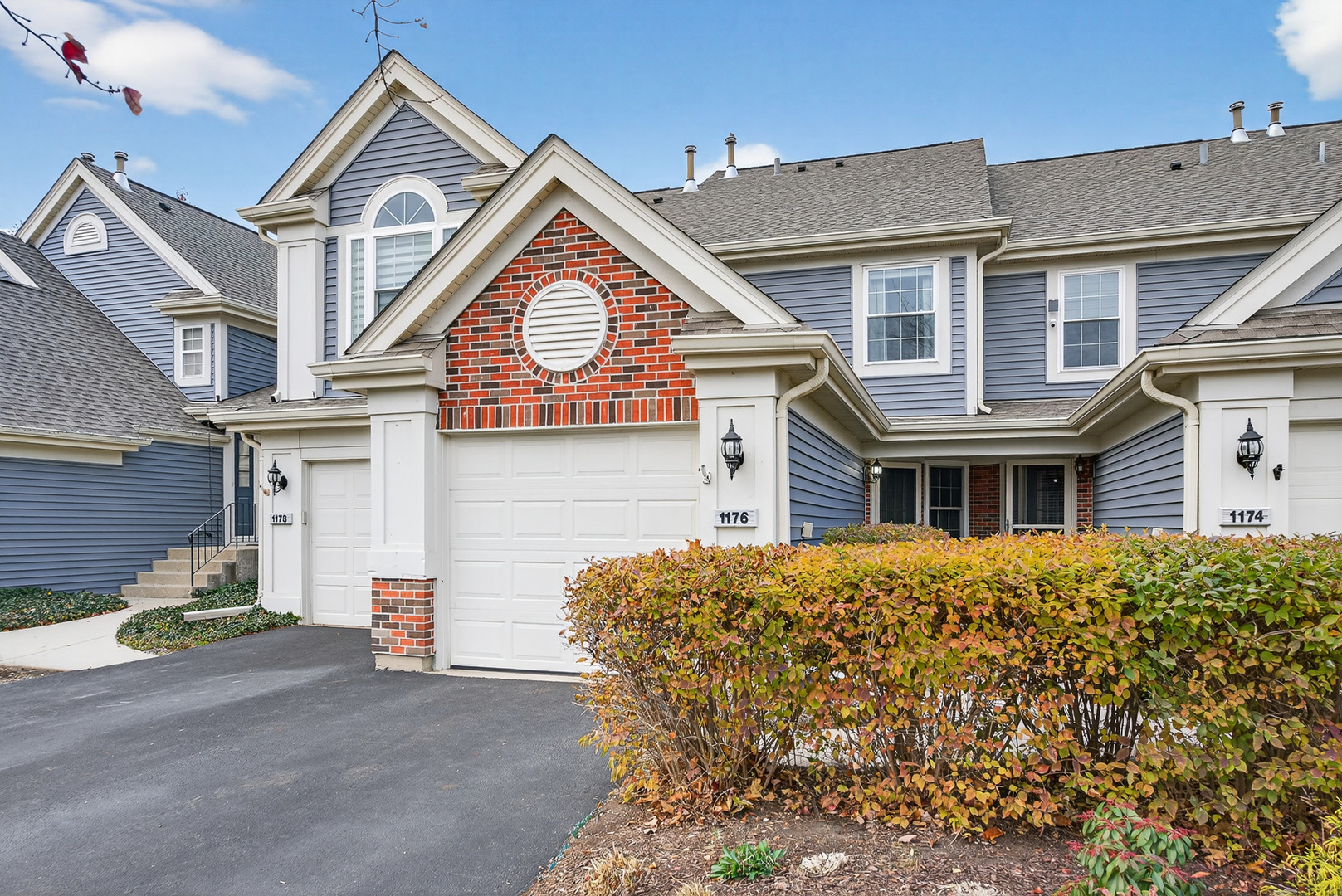 1176 Talbots Lane Elk Grove Village, IL 60007 - Photo 2 of 21 a front view of a house with a yard and garage