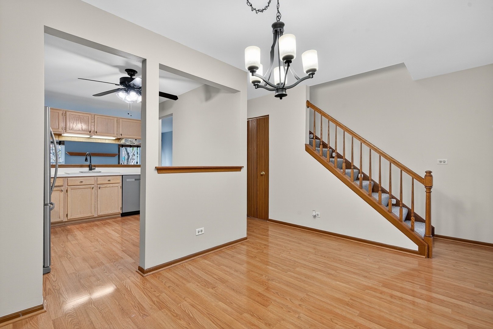 1176 Talbots Lane Elk Grove Village, IL 60007 - Photo 3 of 21 a view of a hallway with wooden floor and chandelier