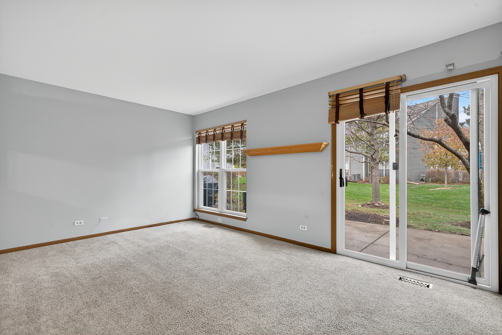 1176 Talbots Lane Elk Grove Village, IL 60007 - Photo 8 of 21 an empty room with sliding glass door and garden view