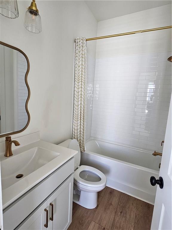 1294 Longreen Terrace Northwest, Unit 2 Atlanta, GA 30318 - Photo 21 of 25 a bathroom with a sink a toilet and shower