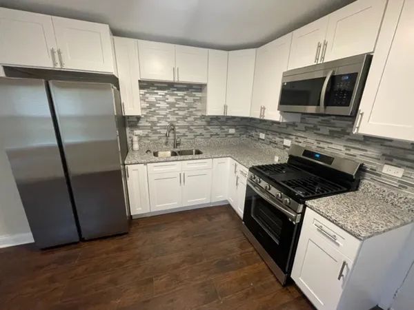 a kitchen with a sink stove and refrigerator