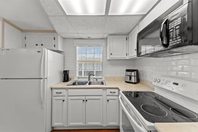 a kitchen with a sink stove and refrigerator