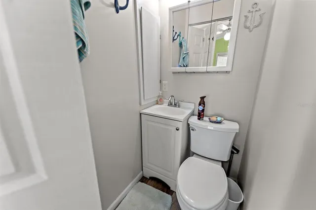 a white toilet sitting next to a bathroom sink
