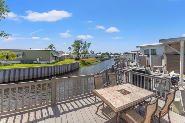 a view of a balcony with wooden furniture