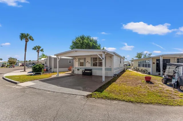 a view of a house with swimming pool and sitting area