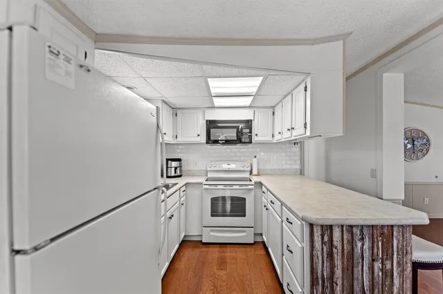 a kitchen with stainless steel appliances a stove and a refrigerator