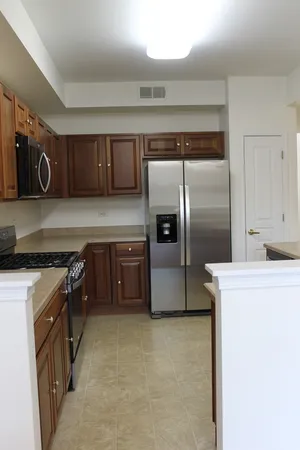 a kitchen with granite countertop a stove and a cabinets