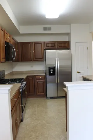 a kitchen with granite countertop a stove and a cabinets