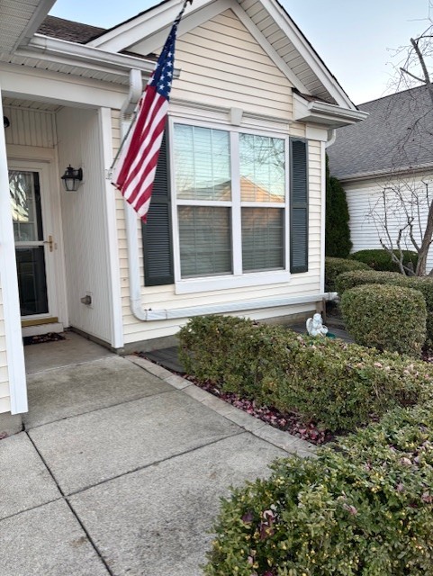 13455 Nealy Road Huntley, IL 60142 - Photo 2 of 22 a front view of a house with a yard and potted plants