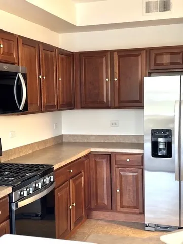 a kitchen with granite countertop a stove and a cabinets