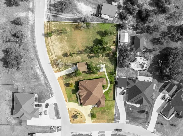 an aerial view of a house with outdoor space