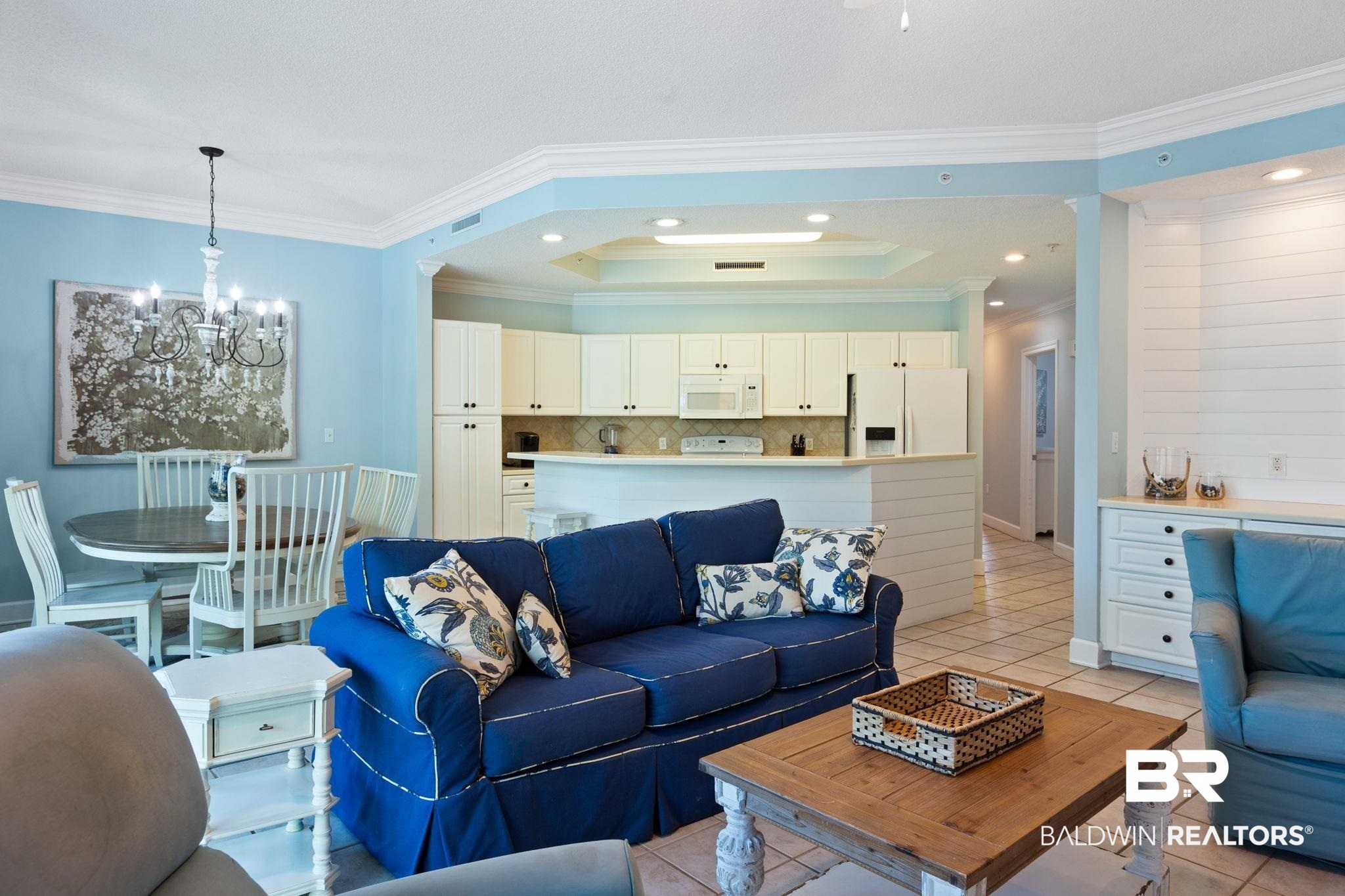 27580 Canal Road, Unit 1112 Orange Beach, AL 36561 - Photo 5 of 50 Living room featuring a tray ceiling, ornamental molding, light tile patterned floors, a chandelier, and recessed lighting