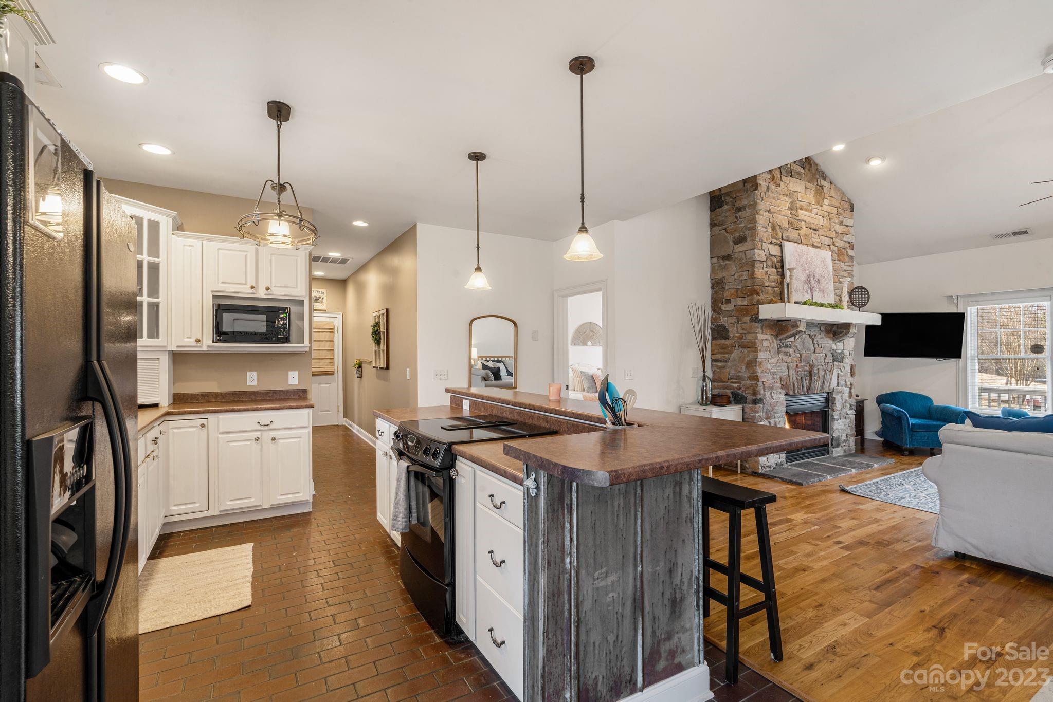874 Burney Mountain Road Fletcher, NC 28732 - Photo 11 of 37 a kitchen with stainless steel appliances granite countertop a sink stove and refrigerator