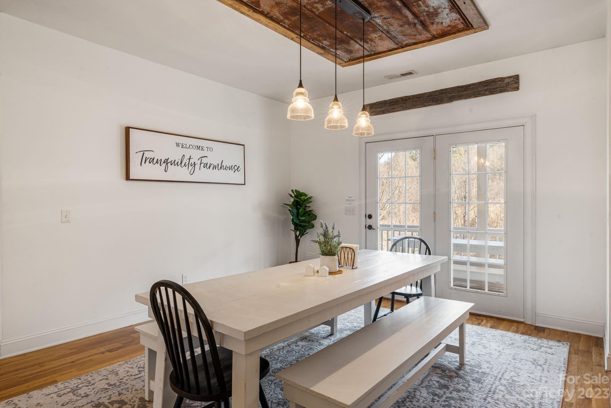 874 Burney Mountain Road Fletcher, NC 28732 - Photo 12 of 37 a view of a dining room with furniture window and wooden floor