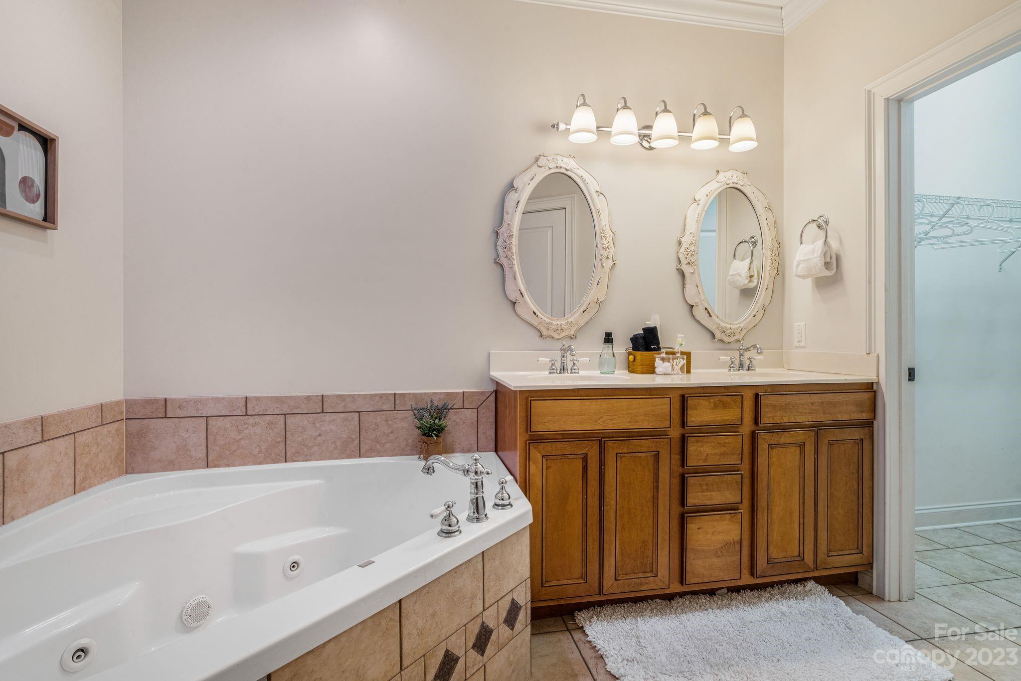 874 Burney Mountain Road Fletcher, NC 28732 - Photo 18 of 37 a bathroom with a tub sink and mirror