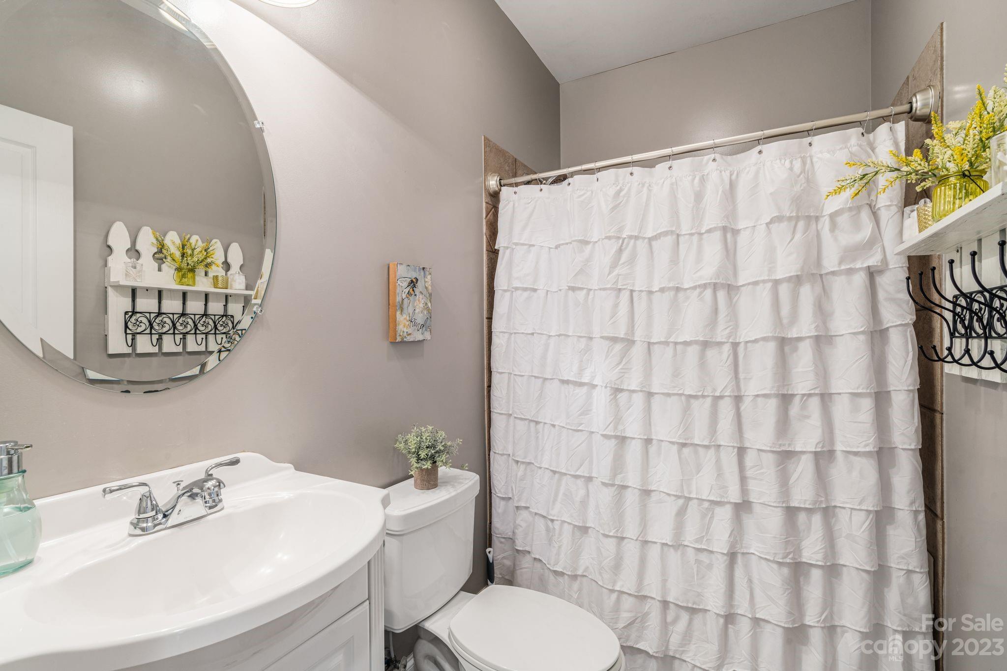 874 Burney Mountain Road Fletcher, NC 28732 - Photo 22 of 37 a bathroom with a sink mirror vanity and toilet