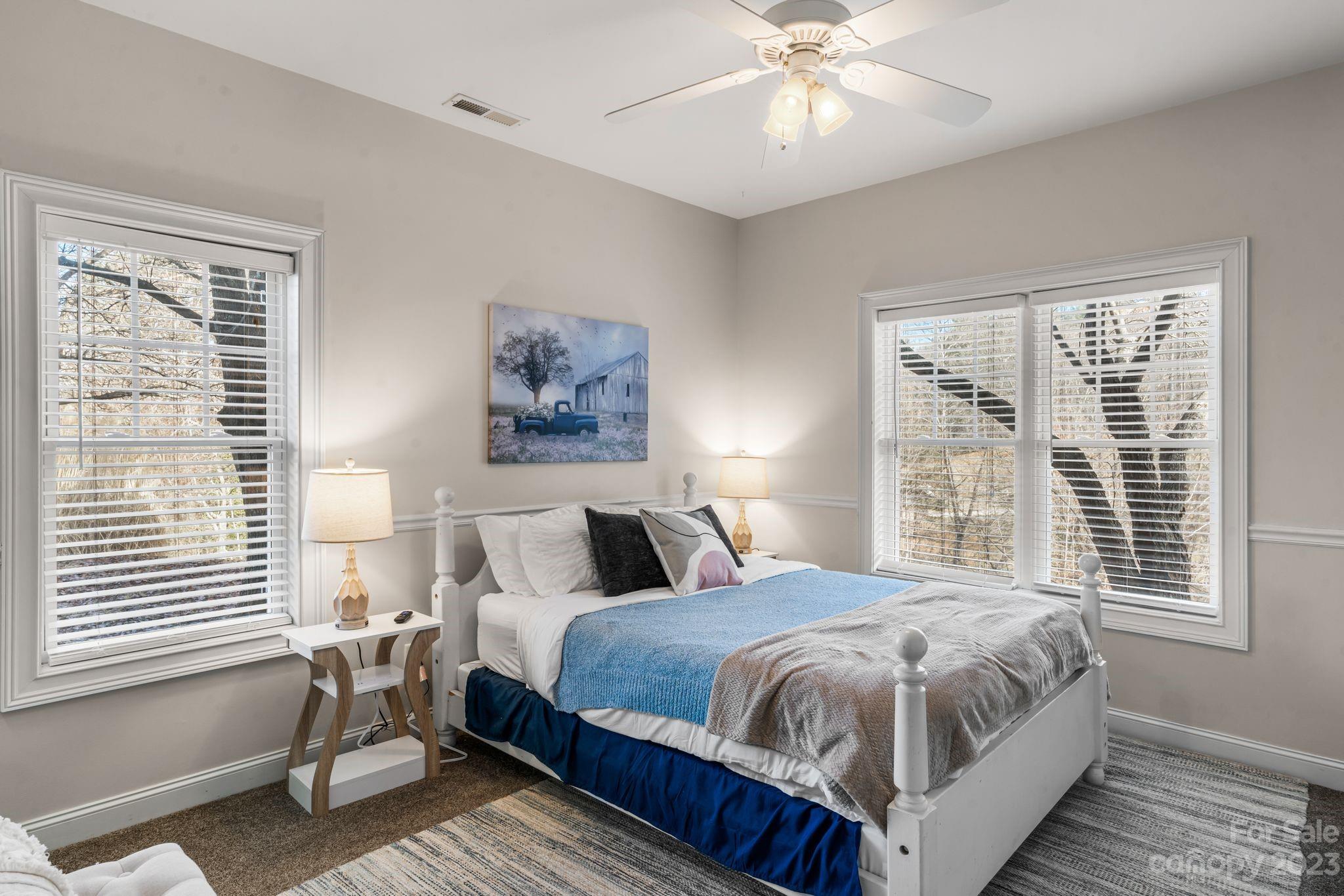 874 Burney Mountain Road Fletcher, NC 28732 - Photo 31 of 37 a bedroom with a bed and a chandelier