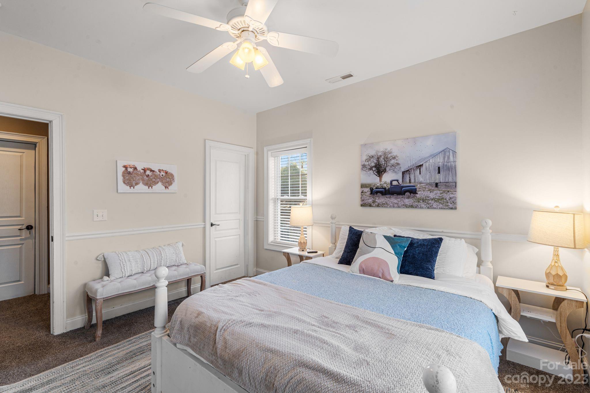 874 Burney Mountain Road Fletcher, NC 28732 - Photo 32 of 37 a bedroom with a bed and a chandelier